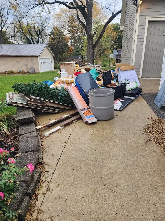 Dumpster being loaded with debris for Estate Cleanout Dumpster Rental in Gilmer